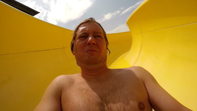 Man on water slide at aqua park