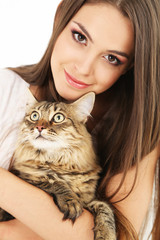 Beautiful young woman holding cat close up