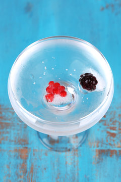 Ice cubes with red currant and blackberry