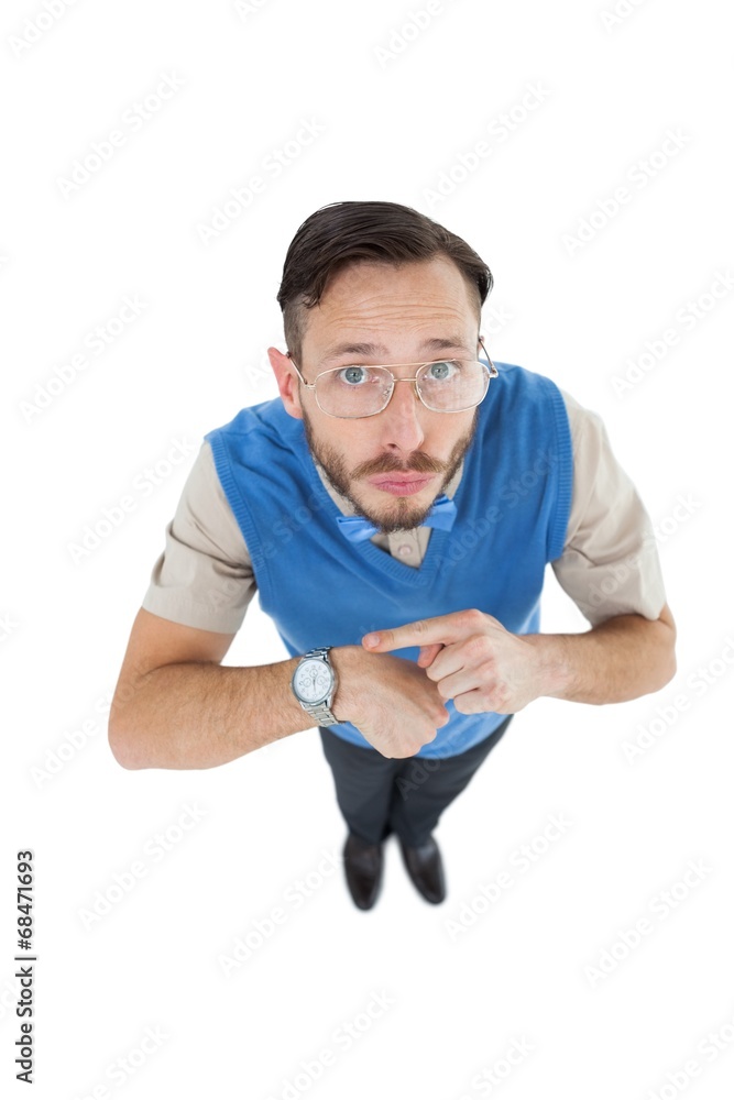 Aufkleber Geeky hipster looking at camera pointing at watch