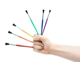 Caucasian male hand holding brushes