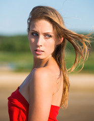 Naklejka premium Beautiful nude woman in red fabric