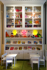 furniture and white table with toys and books for children