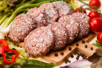 raw meatball on a chopping board and ingredients. horizontal. cl