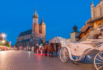 Naklejka na ściany i meble Carriages on The Main Market Square in Krakow