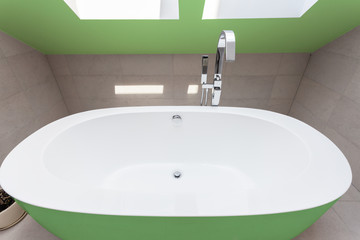 Green bathtub in bathroom