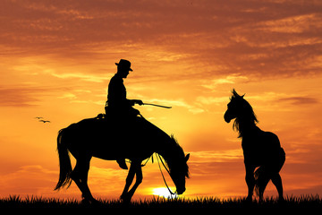 Rodeo cowboy at sunset