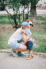 Fashion little boy hugging his mother