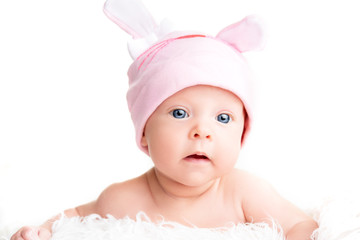 Cute newborn baby girl in a pink hat with ears