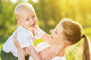 happy Mom and baby son in summer nature