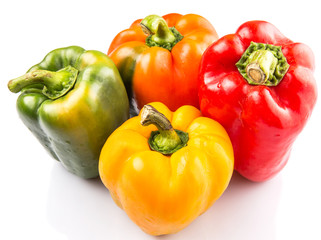 A group of different colors of capsicum over white background