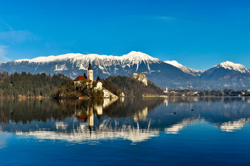 St. Martin Church on Island in Lake Bled with Mountains