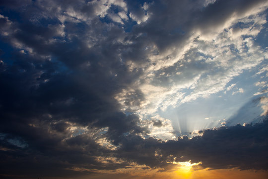 Cloudscape with the sun rays radiating from behind the cloud