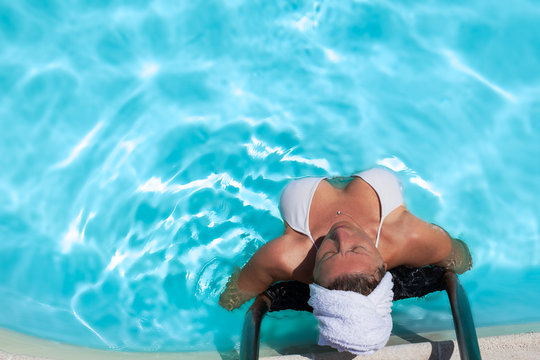 Woman Relaxing In The Swimming Pool