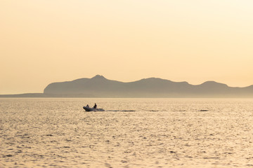 Sunset sea island, motor boat, copy space