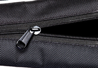 Metal zipper open on black synthetic fabric