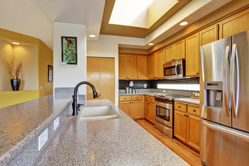 Kitchen room with steel appliances and granite tops
