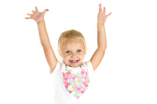 Adorable young girl happy with arms stretched up in the air