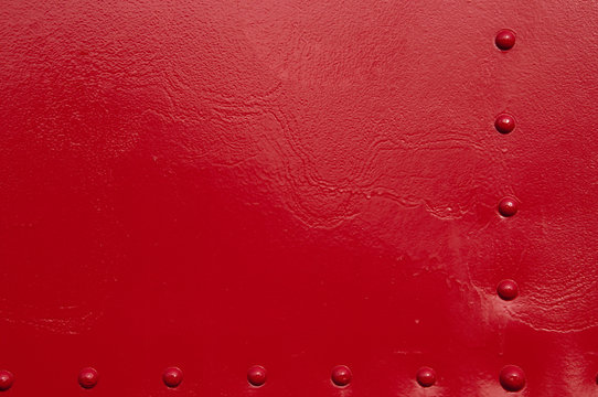 A red painted metal background.