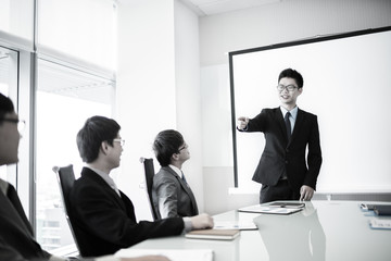 businessman giving a presentation to his colleagues