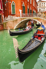 Fototapeta na wymiar Romantic gondolas on canal in Venice, Italy