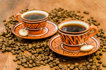 Coffee on a wooden table with coffee grains