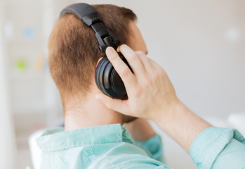 close up of man in headphones at home