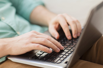 close up of man working with laptop at home