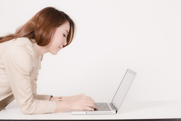 Portrait of a young business woman using laptop at office