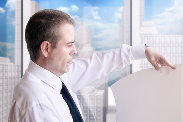 Fototapeta premium Arquitecto de éxito revisando planos de arquitectura delante de la ventana de su oficina. Profesional ingeniero inmerso en su proyecto de construcción. Concepto de negocios