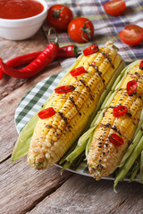 grilled corn with chili and tomatoes  closeup. vertical