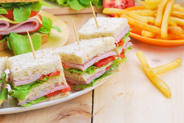 Club Sandwich with Cheese, Pickled Cucumber, Tomato and ham. Gar