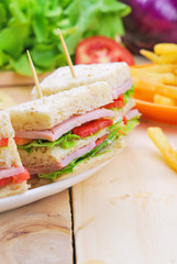 Club Sandwich with Cheese, Pickled Cucumber, Tomato and ham. Gar