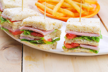 Club Sandwich with Cheese, Pickled Cucumber, Tomato and ham. Gar
