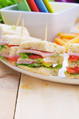 Club Sandwich with Cheese, Pickled Cucumber, Tomato and ham. Gar