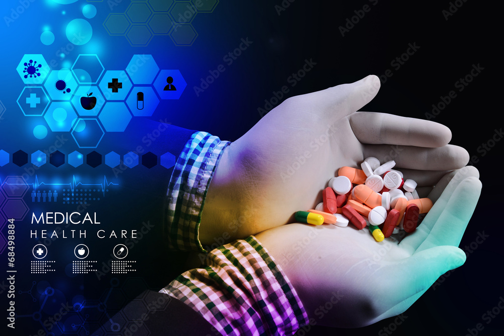 Wall mural doctor holding in hands pills