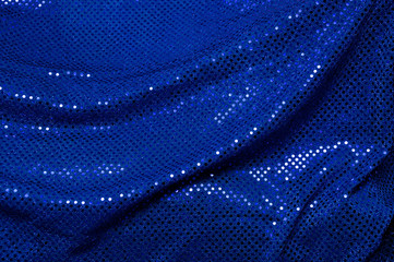 Blue sequined draped fabric background