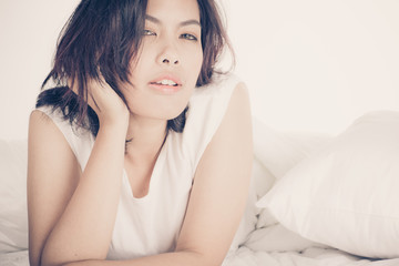 Fototapeta premium Portrait of a beautiful young woman in bed