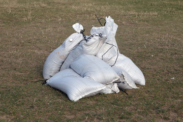 Small pile of full sand bags ready for issue