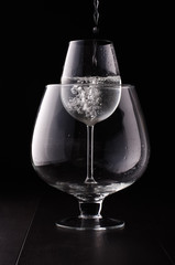 Smaller wine glass in the bigger one