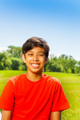 Brunet happy boy in red T-shirt portrait