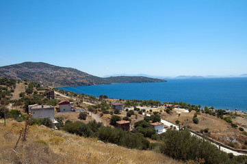 Fototapeta na wymiar Aegean sea surrounded by hills on a sunny day