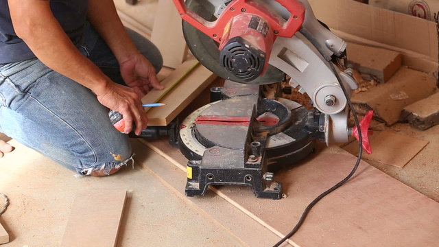 carpenter use saw cut wood for make new furniture