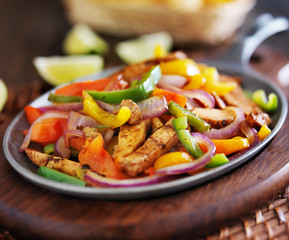 mexican chicken fajitas in iron skillet with peppers
