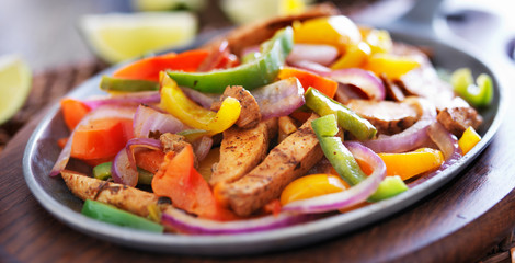 mexican chicken fajitas in iron skillet with peppers