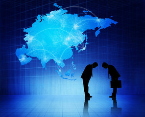 Two Silhouettes Of Businessmen With Blue Map