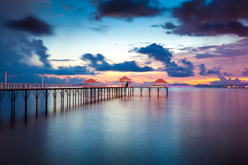 Sunset pier along coast