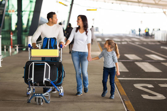 traveling family with suitcases at airport