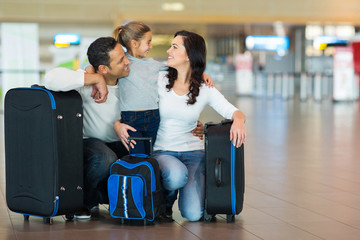family hugging at airport