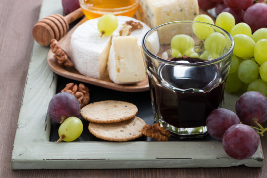 Assorted appetizers to wine - cheese, grapes, crackers and honey